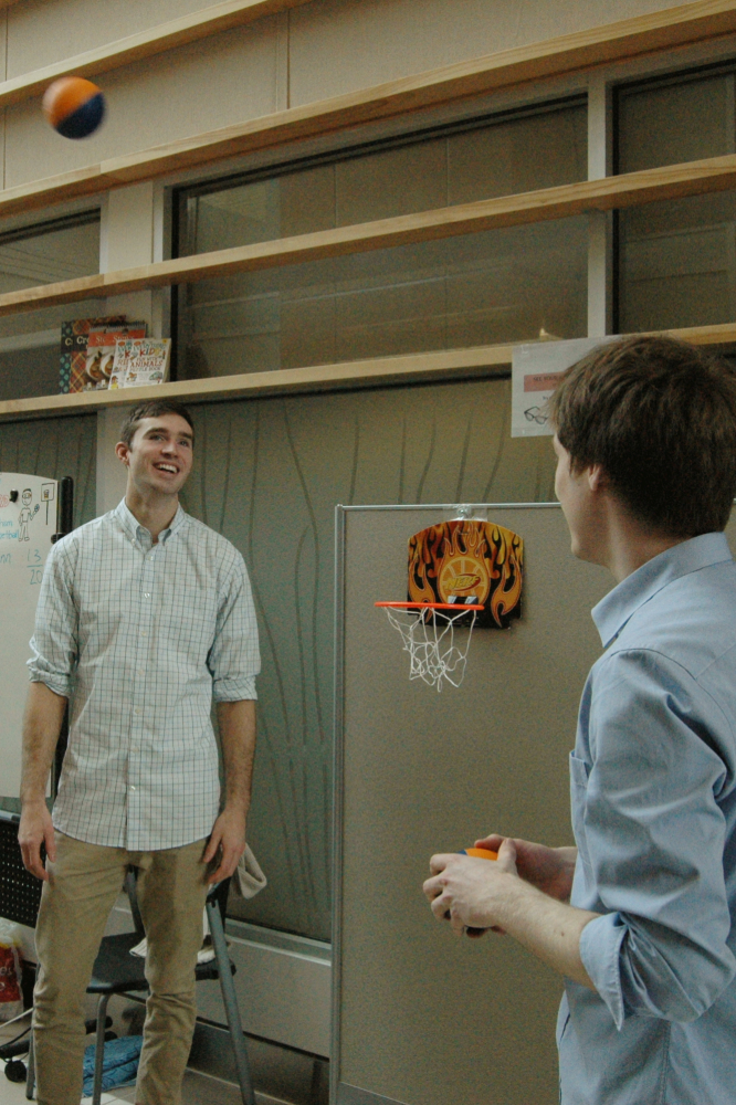 Master's student Stephane MacLean and Software Developer Jacob Kroeker use basketball to teach visitors about our research in PRISM adaptation.